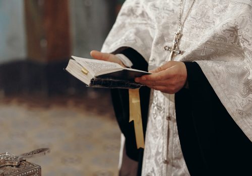 Priest reading holy bible in christian church during orthodox wedding ceremony